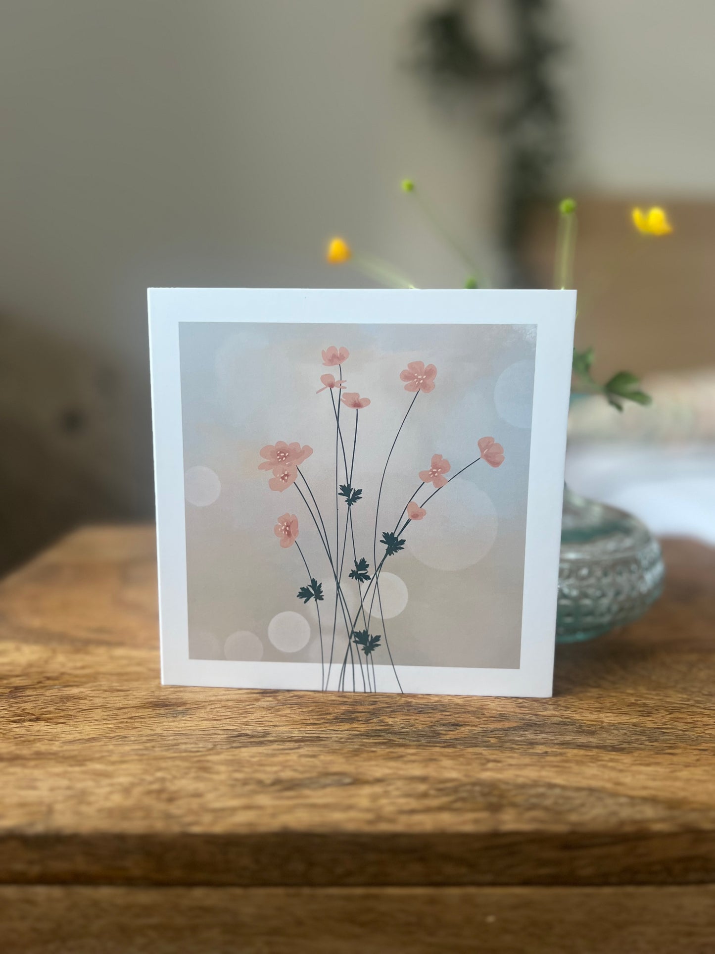 Delicate pink flower greeting card with hazy background