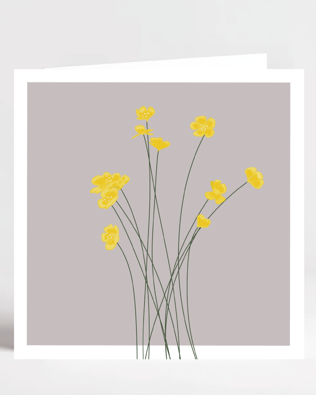 Yellow buttercup greetings card on grey background